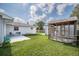 Backyard with a shed and open grassy area at 144 Mirror Nw Ln, Winter Haven, FL 33881