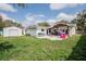 Backyard with an entertainment patio, a storage shed, and a fenced yard at 144 Mirror Nw Ln, Winter Haven, FL 33881