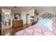 Bedroom with light pink bedding, hardwood floors, and decorated walls at 144 Mirror Nw Ln, Winter Haven, FL 33881