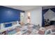 Bright bedroom featuring blue accent wall, white furniture and an adjacent study at 144 Mirror Nw Ln, Winter Haven, FL 33881