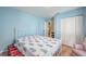 Comfortable bedroom with light blue walls, double closet and tiled floor at 144 Mirror Nw Ln, Winter Haven, FL 33881