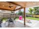 Covered patio area with a ceiling fan, outdoor table, and a picnic table at 144 Mirror Nw Ln, Winter Haven, FL 33881