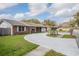 The wide driveway accesses the garage of this single-story brick house at 144 Mirror Nw Ln, Winter Haven, FL 33881