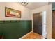 Cozy entryway with wainscoting, tiled floor, and natural light at 144 Mirror Nw Ln, Winter Haven, FL 33881