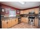 The well-lit kitchen features stainless steel appliances and maple wood cabinets at 144 Mirror Nw Ln, Winter Haven, FL 33881