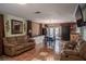 Cozy living room with tile floors, comfortable furniture, and a view to the kitchen at 144 Mirror Nw Ln, Winter Haven, FL 33881