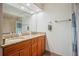 Bathroom with double sinks, granite countertops, wood cabinets and a shower/tub combo at 15 Tera Ln, Winter Haven, FL 33880