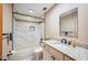 Updated bathroom featuring granite counters, white cabinets, white tile and black hardware at 15 Tera Ln, Winter Haven, FL 33880