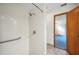 Bright shower featuring white tile, a grab bar, and a view of a bedroom with blue carpet at 15 Tera Ln, Winter Haven, FL 33880