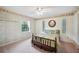 Traditional bedroom featuring decorative wallpaper, ceiling fan and carpeted floor at 15 Tera Ln, Winter Haven, FL 33880