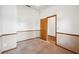 The carpeted bedroom features white walls with a window and a wooden door at 15 Tera Ln, Winter Haven, FL 33880