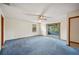 Bedroom featuring a sliding glass door to the patio, carpet, window and ceiling fan at 15 Tera Ln, Winter Haven, FL 33880