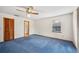 Bedroom featuring a window, wood closet doors, and ensuite bathroom at 15 Tera Ln, Winter Haven, FL 33880