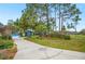 View of the front exterior showing the long driveway leading up to the home at 15 Tera Ln, Winter Haven, FL 33880