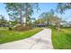 View of the front exterior showing the curved driveway leading up to the home at 15 Tera Ln, Winter Haven, FL 33880