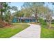 View of the home from across the front yard, showing the long, curved driveway at 15 Tera Ln, Winter Haven, FL 33880