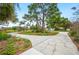 Expansive circular driveway leads to a charming home with mature trees and lush landscaping at 15 Tera Ln, Winter Haven, FL 33880