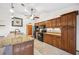 Well-equipped kitchen featuring granite counters, wooden cabinets, and black appliances at 15 Tera Ln, Winter Haven, FL 33880