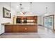 Well-lit kitchen features wood cabinets, granite countertops, black appliances and a breakfast bar at 15 Tera Ln, Winter Haven, FL 33880