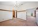 Open living room featuring wood trim, carpet, and a view to the kitchen and brick fireplace at 15 Tera Ln, Winter Haven, FL 33880