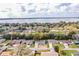 Aerial view of homes with mature trees and a scenic lake in the background at 1548 Churchill Ct, Lakeland, FL 33801