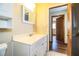 Bathroom featuring a white vanity and tile flooring with a doorway to the bedroom at 1548 Churchill Ct, Lakeland, FL 33801