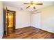 This bedroom has laminate floors, a ceiling fan, and a double closet with an ensuite bathroom at 1548 Churchill Ct, Lakeland, FL 33801