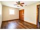 Bedroom featuring laminate floors, a ceiling fan, and a wooden double door closet at 1548 Churchill Ct, Lakeland, FL 33801