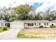 Charming single-story home with a well-manicured lawn and attached two-car garage at 1548 Churchill Ct, Lakeland, FL 33801