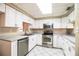 Well-lit kitchen with stainless steel appliances, tile floors, and white cabinets at 1548 Churchill Ct, Lakeland, FL 33801