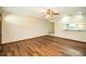 Bright living room featuring hardwood floors, a ceiling fan, and ample natural light at 1548 Churchill Ct, Lakeland, FL 33801