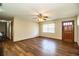 Inviting living room with hardwood floors, a ceiling fan, and a front door entrance at 1548 Churchill Ct, Lakeland, FL 33801