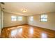 Open-concept living room with wood floors, and multiple windows providing natural light at 1548 Churchill Ct, Lakeland, FL 33801