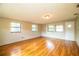 Spacious living room with wood floors, three large windows, and great natural light at 1548 Churchill Ct, Lakeland, FL 33801