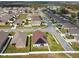 Expansive aerial view of a suburban neighborhood showcasing well-maintained homes and landscaping at 1706 Tressel Ct, Winter Haven, FL 33881