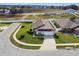 An aerial view of a single-Gathering home with a well-maintained lawn and landscaping at 1706 Tressel Ct, Winter Haven, FL 33881