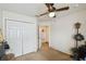 Bedroom featuring a ceiling fan, a double door closet, and an open doorway at 1706 Tressel Ct, Winter Haven, FL 33881