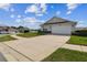 Attractive home exterior with lush green lawn, and a spacious two car garage at 1706 Tressel Ct, Winter Haven, FL 33881