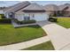 Charming single-story home with a well-manicured lawn and attached two car garage at 1706 Tressel Ct, Winter Haven, FL 33881