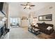 Inviting living room featuring a sliding door and a comfortable brown sofa. A ceiling fan provides ample air circulation at 1706 Tressel Ct, Winter Haven, FL 33881