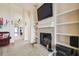 Cozy living room with a fireplace, built-in shelving, and a view into other rooms, creating an open feel at 1706 Tressel Ct, Winter Haven, FL 33881