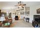 Spacious living room with plush carpet, ceiling fan, and decorative shelving for a cozy and inviting atmosphere at 1706 Tressel Ct, Winter Haven, FL 33881