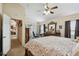 Spacious main bedroom with a dresser and access to a sunroom. Features a ceiling fan and neutral color scheme at 1706 Tressel Ct, Winter Haven, FL 33881