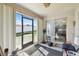 Enclosed sunroom with views of the fenced yard, a sliding glass door to a bedroom and an exterior door at 1706 Tressel Ct, Winter Haven, FL 33881