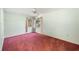 Bright bedroom with light green walls, pink carpet, and ceiling fan at 2025 Sylvester Rd # N106, Lakeland, FL 33803