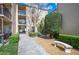 Charming condo building featuring well-maintained landscaping, a walkway, and inviting benches at 2025 Sylvester Rd # N106, Lakeland, FL 33803