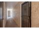 Hallway with neutral colored walls and a security gate at 2025 Sylvester Rd # N106, Lakeland, FL 33803