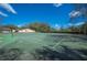 Full tennis court with a net, trees and foliage on the perimeter at 2025 Sylvester Rd # N106, Lakeland, FL 33803