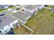 Aerial shot of the property displaying a well-maintained lawn, backyard, and neighborhood layout at 2027 Airedale Way, Lake Alfred, FL 33850