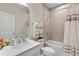 Well-lit bathroom with tile shower and flooring, white vanity, and modern fixtures at 2027 Airedale Way, Lake Alfred, FL 33850